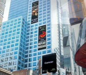 A color photo of Times Square in New York City showing a promotion for Esophageal Cancer Awareness Month