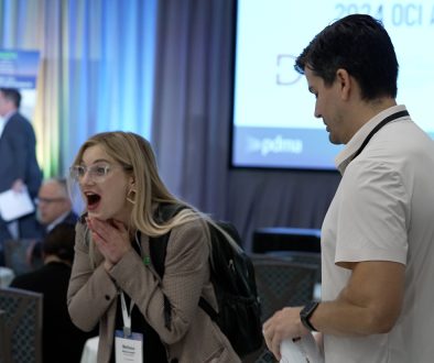 a color photo of a woman reacting to being announced as an award winner